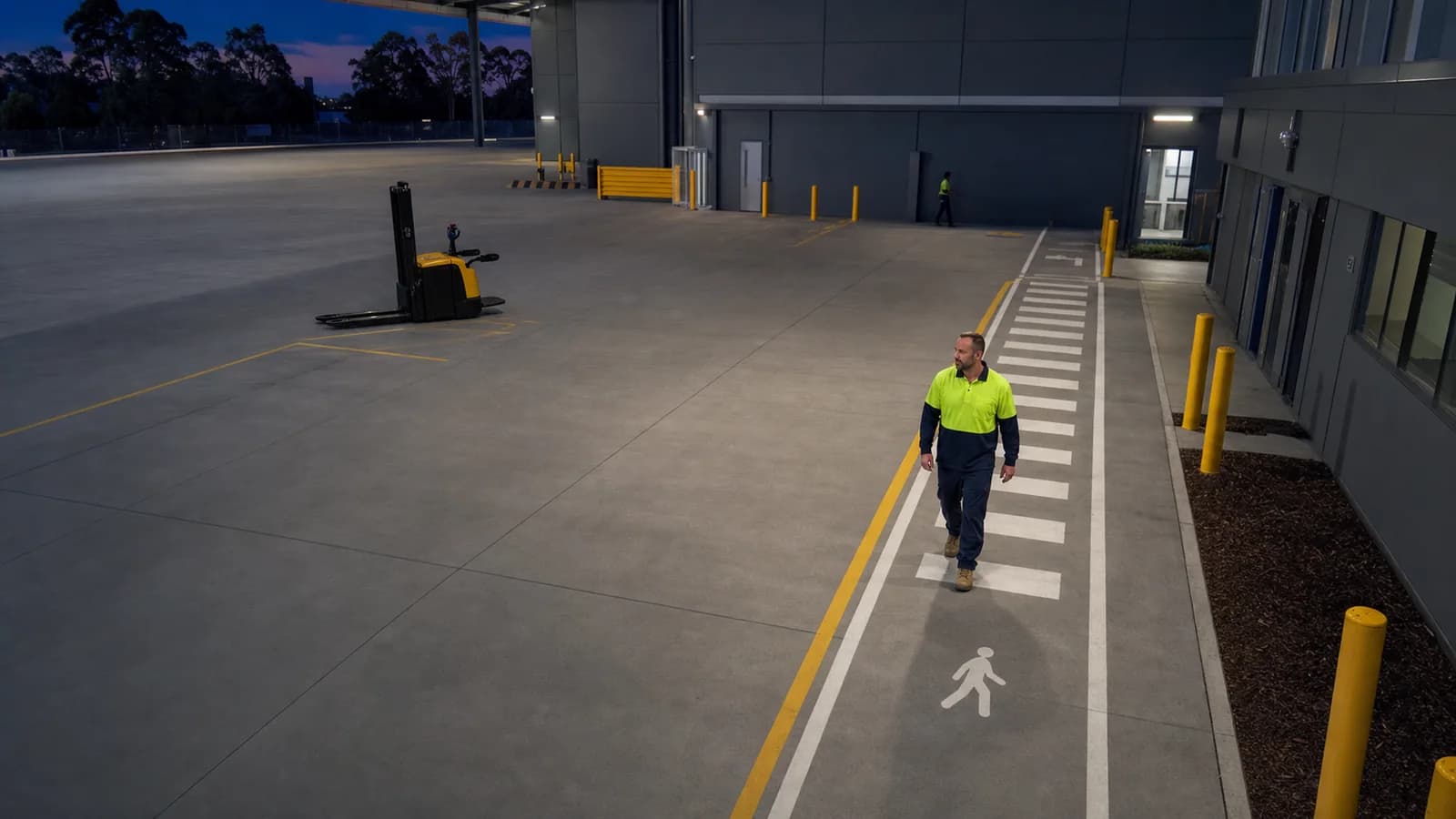 Australian warehouse pedestrian lane with a worker walking clear of equipment
