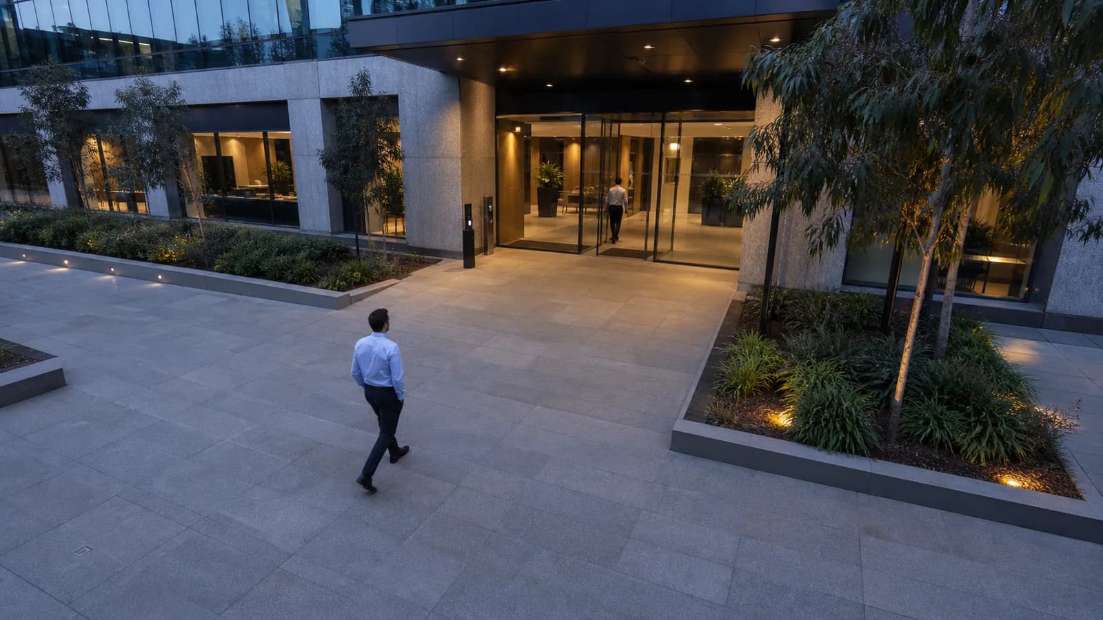 Australian office entrance with two people approaching an access-controlled doorway